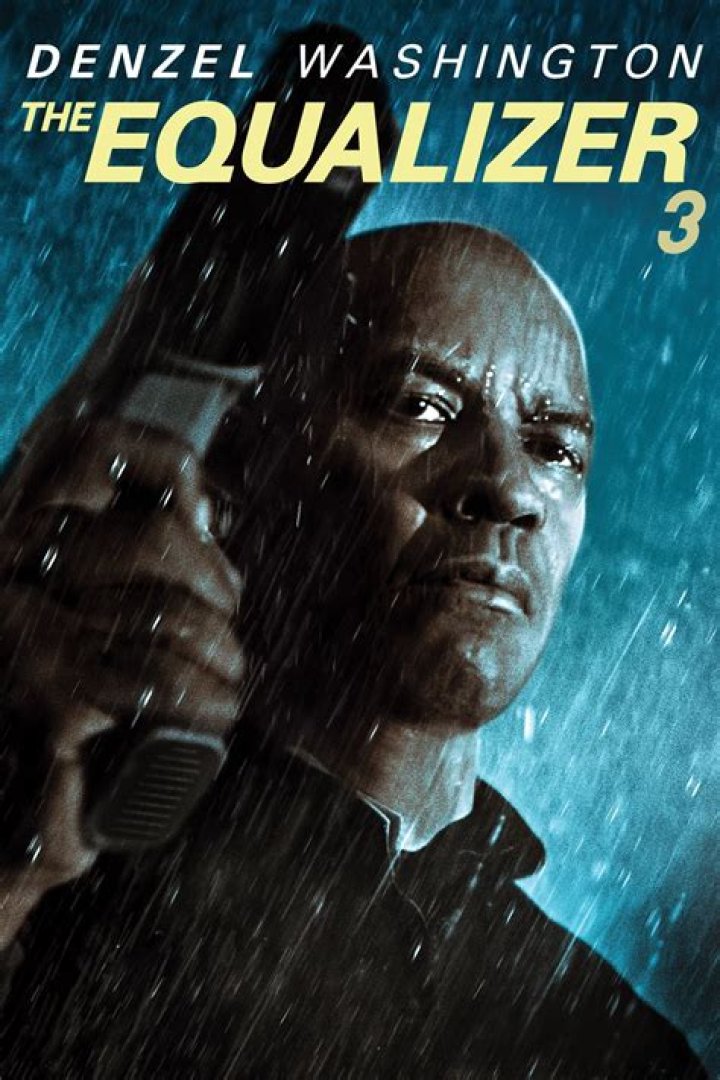 A character in The Equalizer is holding up a police badge in a car.