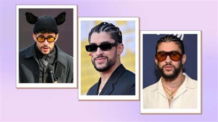 Bad Bunny is wearing sunglasses and a puffer jacket on the red carpet.