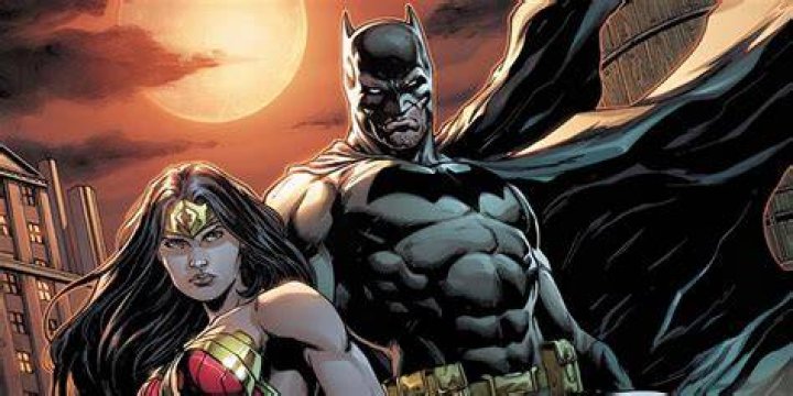 Batman is standing with Wonder Woman and The Flash.