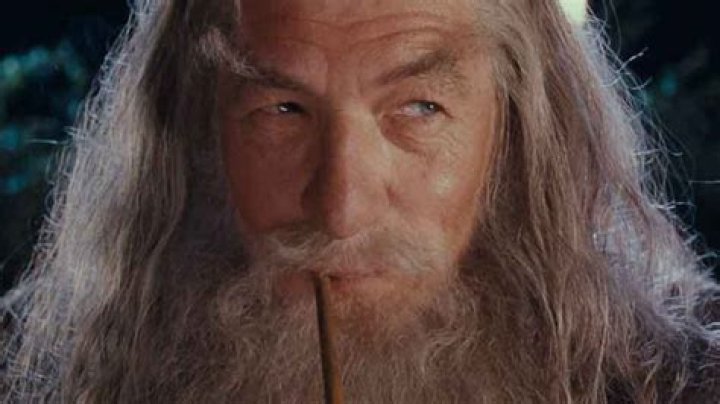 Gandalf is looking at a sword in Lord of the Rings.