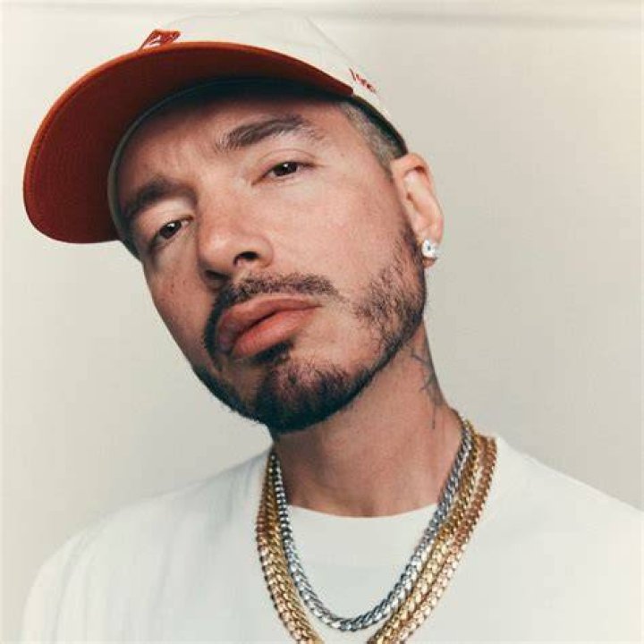 J Balvin posing alongside monkeys