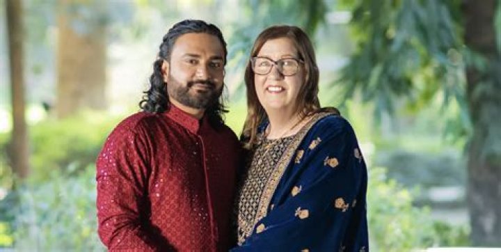 Jenny and Sumit hold hands in India.