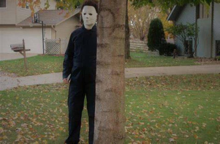 Michael Myers is standing in the doorway of a closet. 