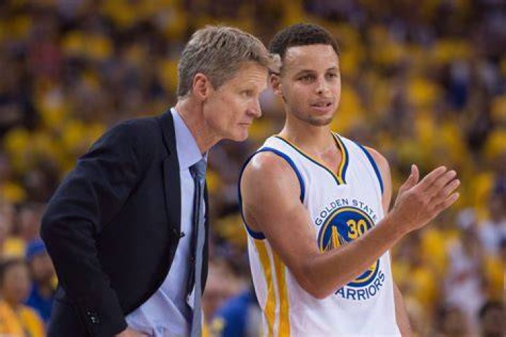 Steph Curry celebrates while Steve Kerr coaches